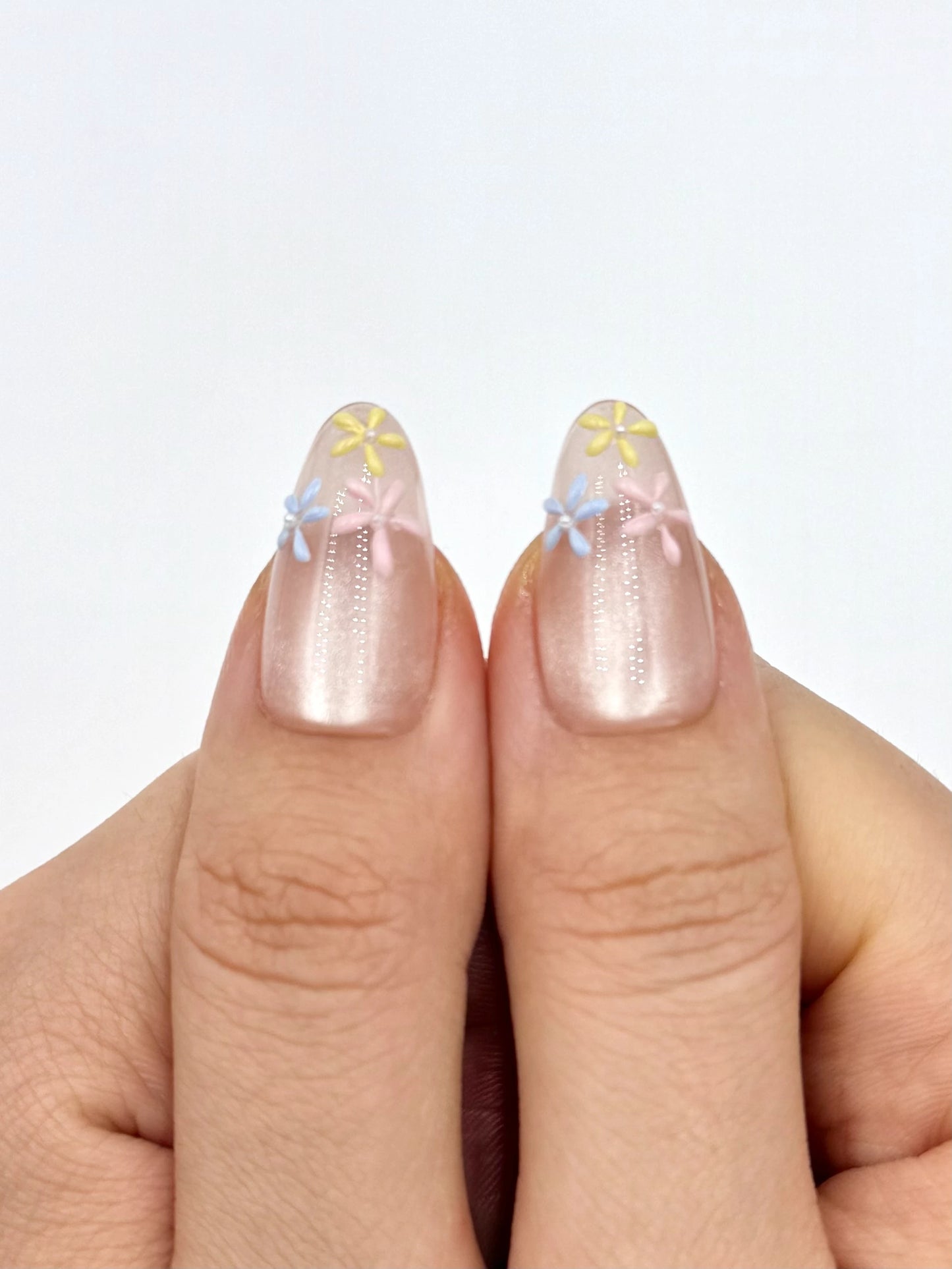 Glowy Nude Cat-Eye Almond Oval Press-On Nails with Handpainted Dainty Flowers in Blue Yellow and Pink