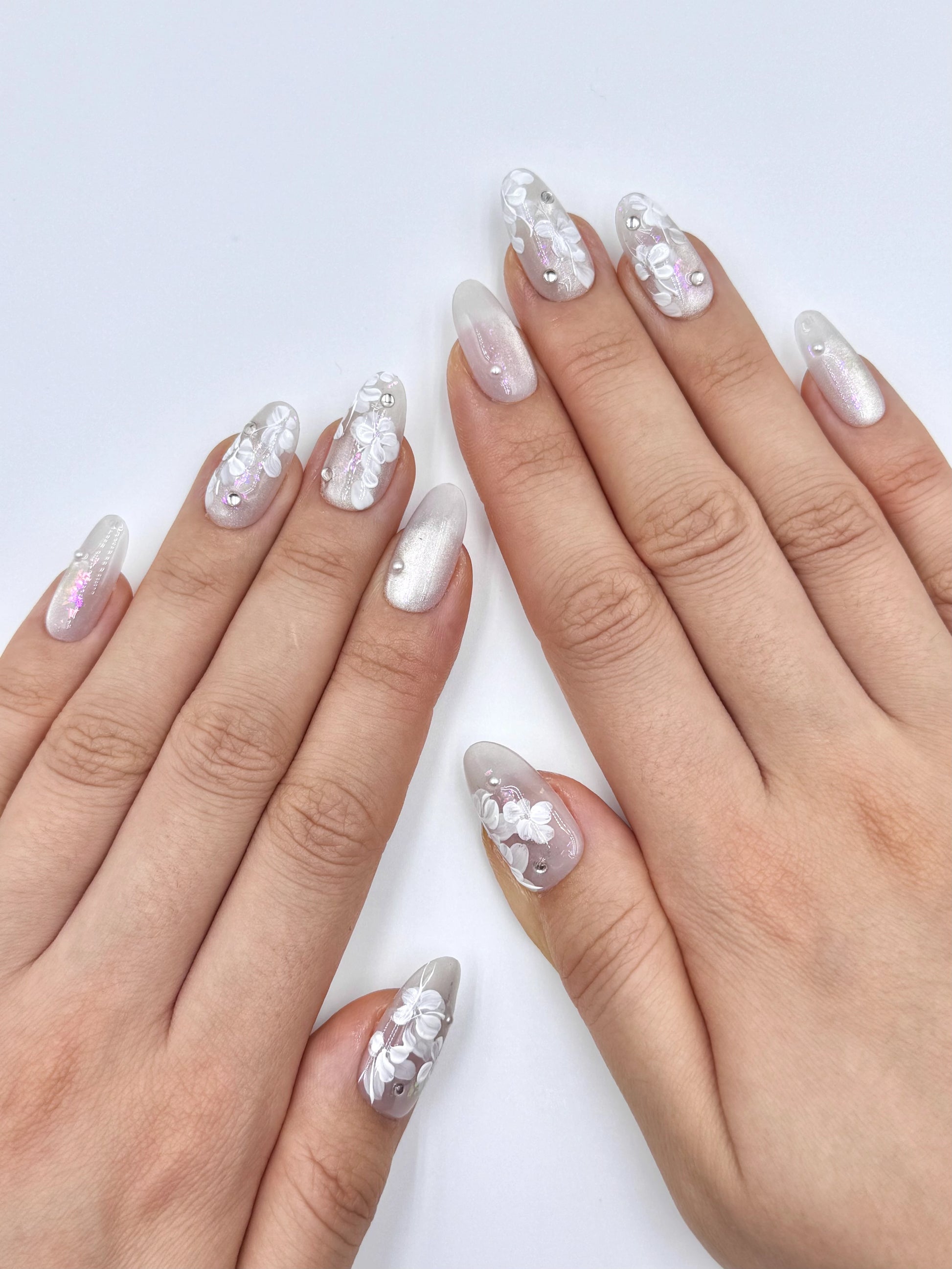 Glowy Silver White Nude Cat-Eye Oval Press-On Nails with Handpainted White Flower, Shiny Crystal Jewelry and Pink Iridescent shimmer