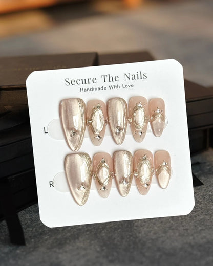Jewelry-Inspired Champagne Nude Cat-Eye Almond Press-On Nails with Crystal and Gold Chrome