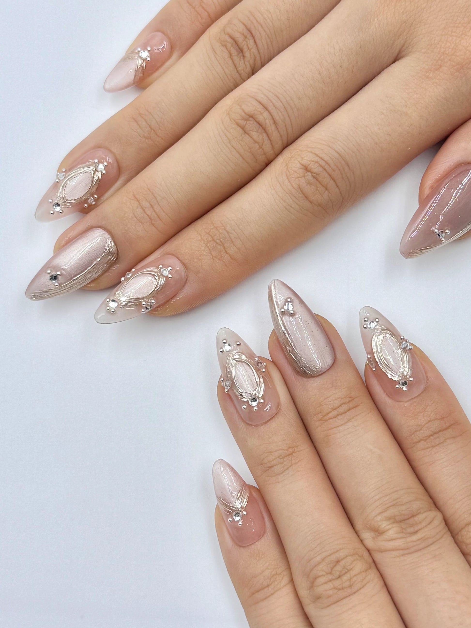 Shimmery Champagne Pinky Nude Cat-Eye Almond Press-On Nail with Shiny Crystal Jewelry and Gold Chrome Frame