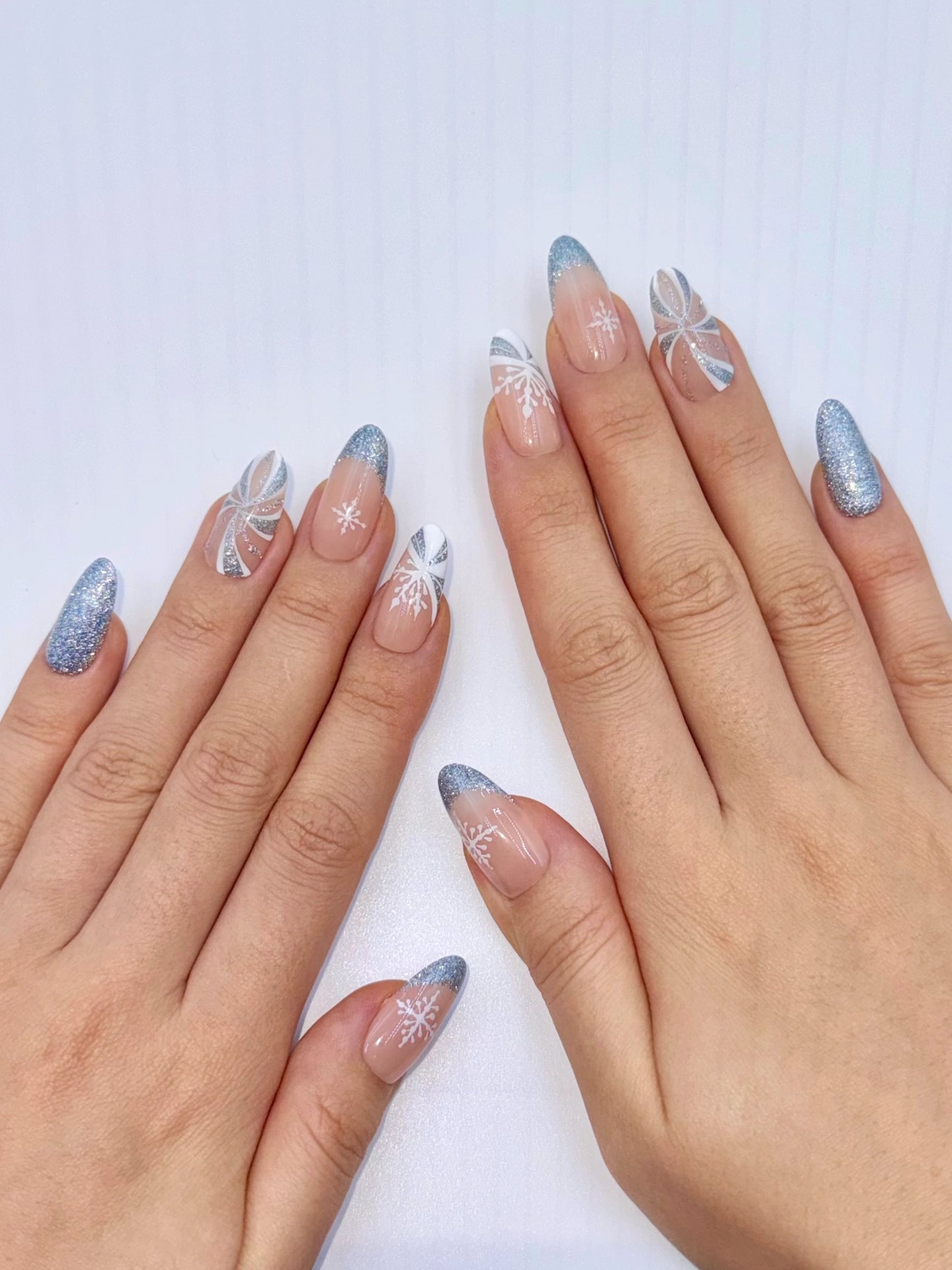 Christmas Holiday Reflective Sparkly Icy Blue Snowflake Candy Cane Almond Oval French Tip Press-On Nails, Flash Glitter Gel, Unique Cute Winter Nail Art Design | Secure The Nails