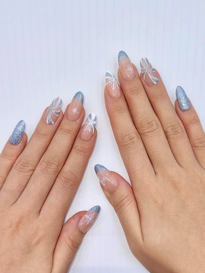 Christmas Holiday Reflective Sparkly Icy Blue Snowflake Candy Cane Almond Oval French Tip Press-On Nails, Flash Glitter Gel, Unique Cute Winter Nail Art Design | Secure The Nails