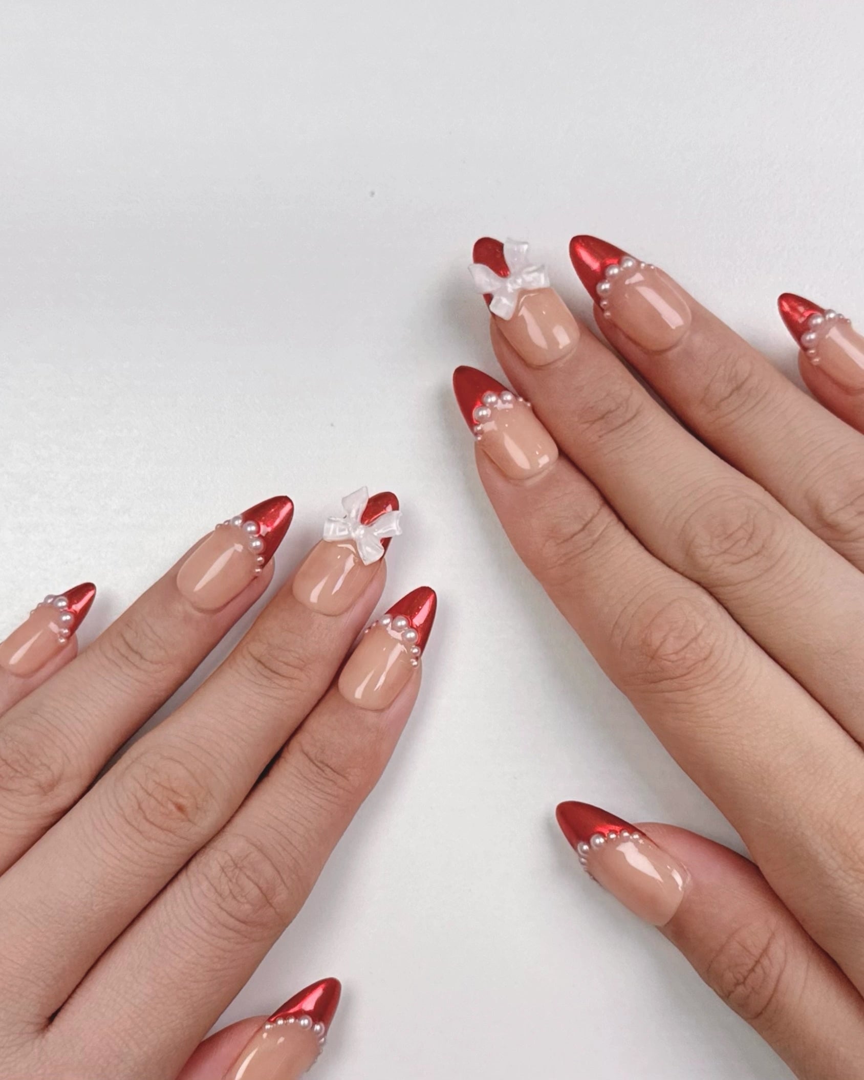 Cute Elegant Christmas Holiday Red Chrome Almond French Tip Press-On Nails with Pearls and Bow Ribbon Winter Nail Art | Secure The Nails