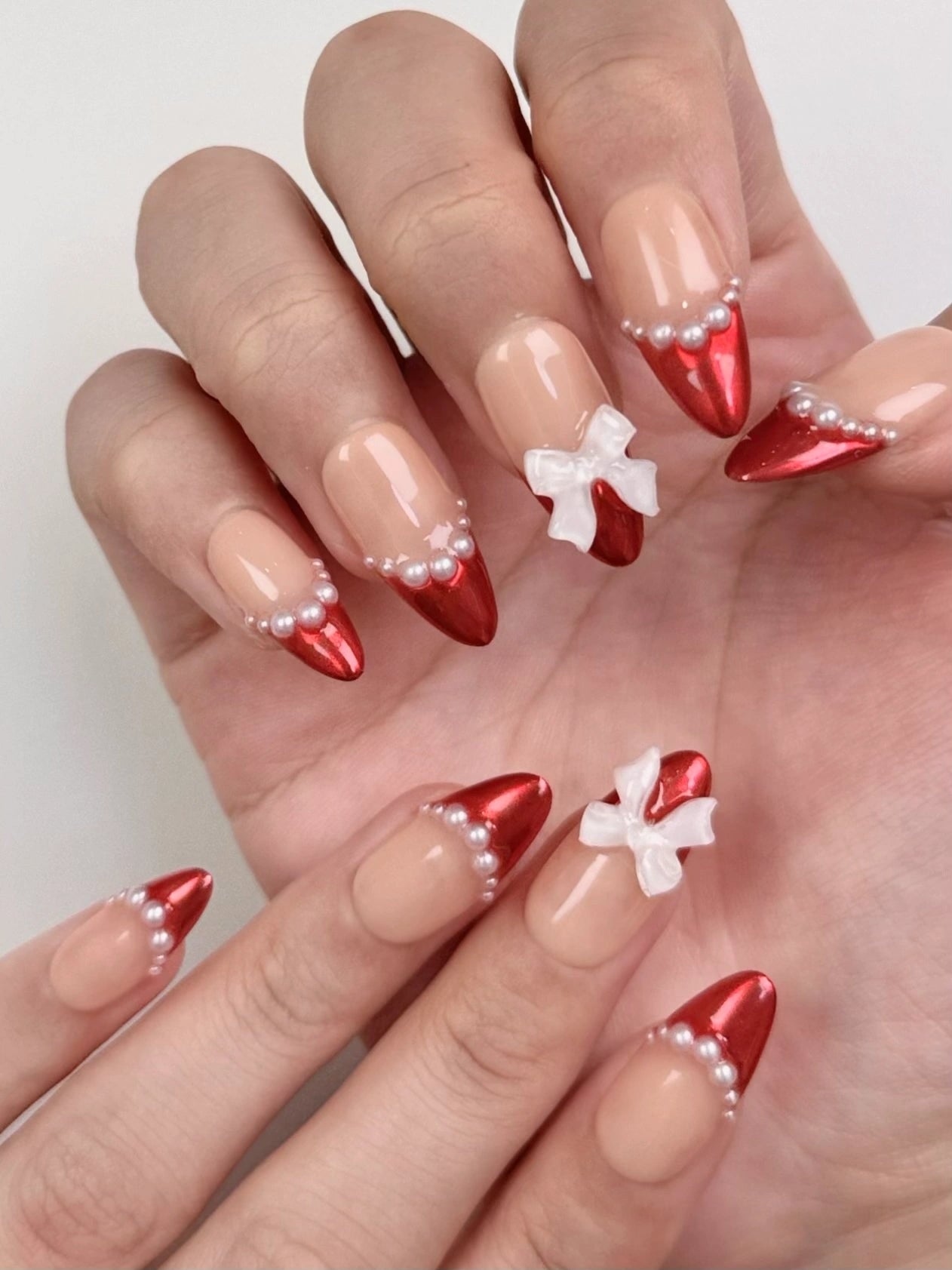 Cute Elegant Christmas Holiday Red Chrome Almond French Tip Press-On Nails with Pearls and Bow Ribbon Girly Winter Nail Art | Secure The Nails