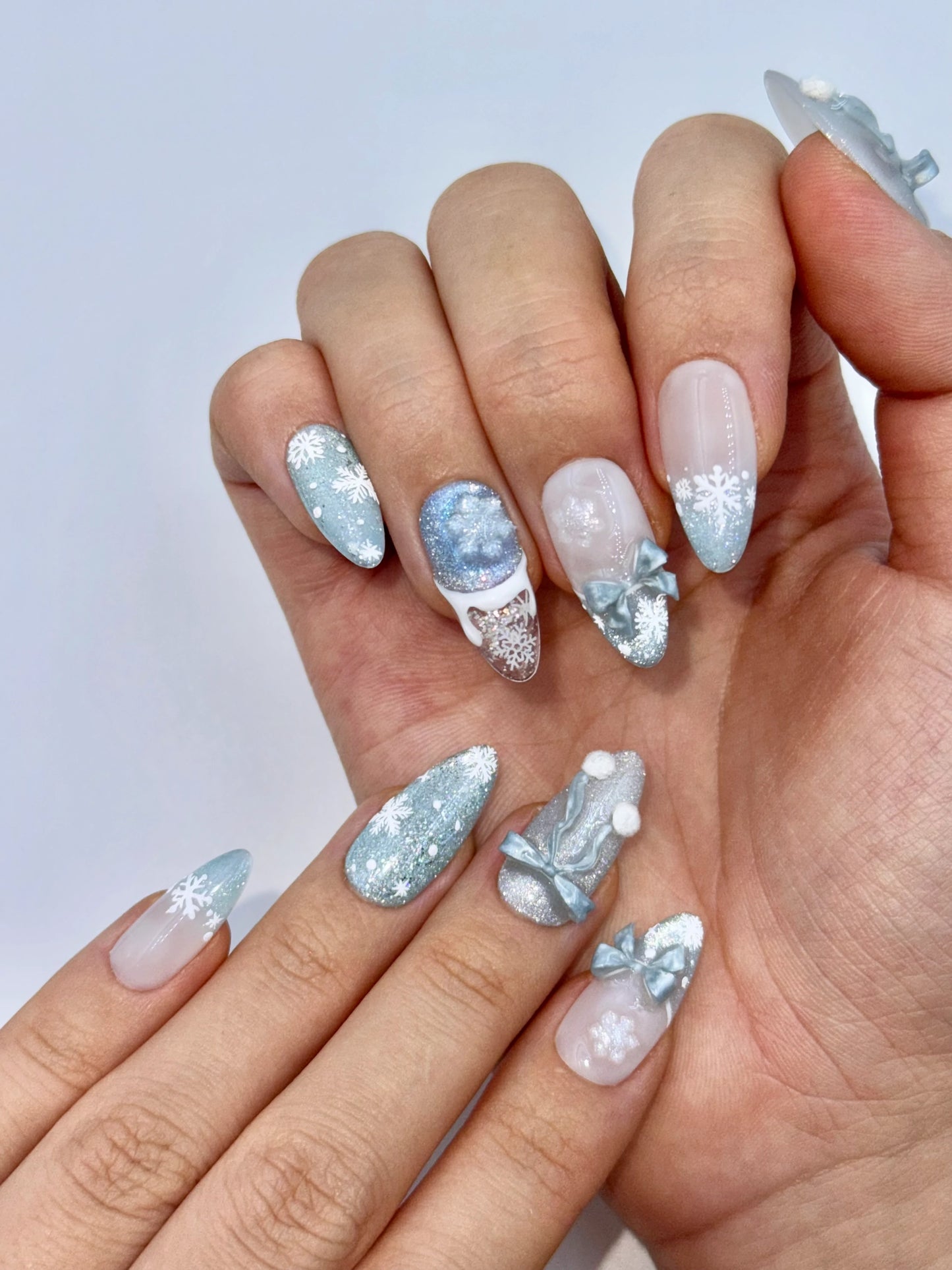 Cute Girly Christmas Holiday Snowflake Bow Ribbon Almond French Tip Press-On Nails with Fluffy Pom-Poms, Unique Winter Snow Nail Art | Secure The Nails