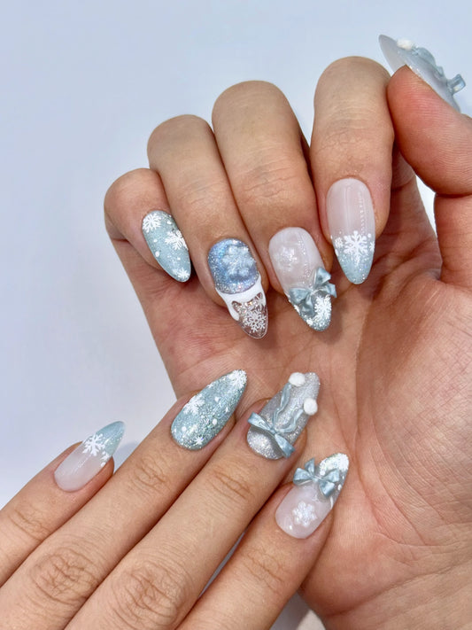 Cute Girly Christmas Holiday Snowflake Bow Ribbon Almond French Tip Press-On Nails with Fluffy Pom-Poms, Unique Winter Snow Nail Art | Secure The Nails